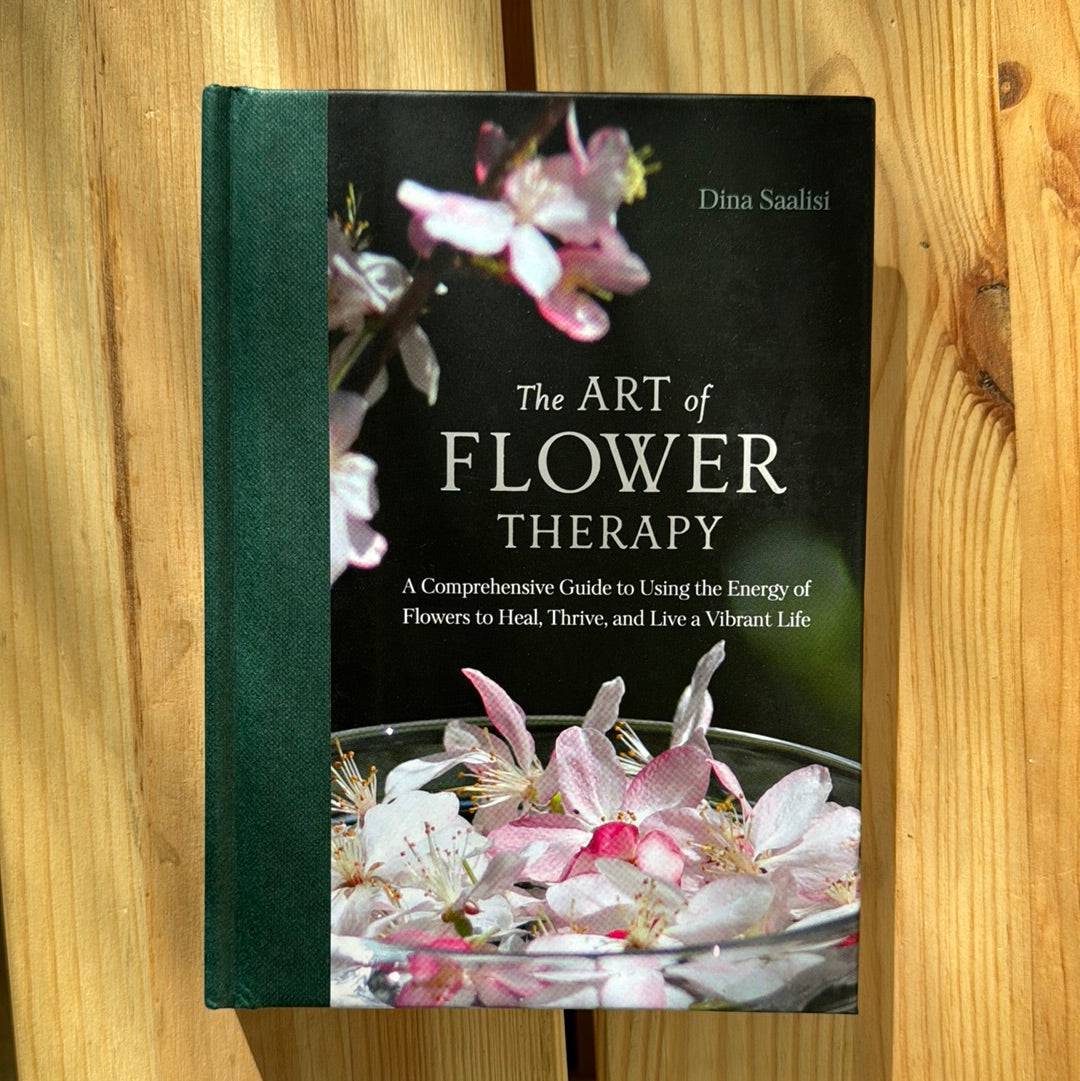 Book titled "The Art of Flower Therapy" by Sacred Light Soundbaths and Crystals, featuring vibrant floral cover art.