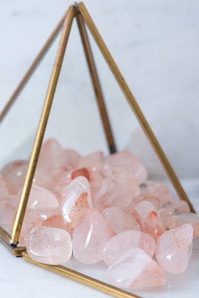 Tumbled Hematoid Quartz stone from Sacred Light Soundbaths and Crystals, showcasing its reddish and transparent mineral appearance.
