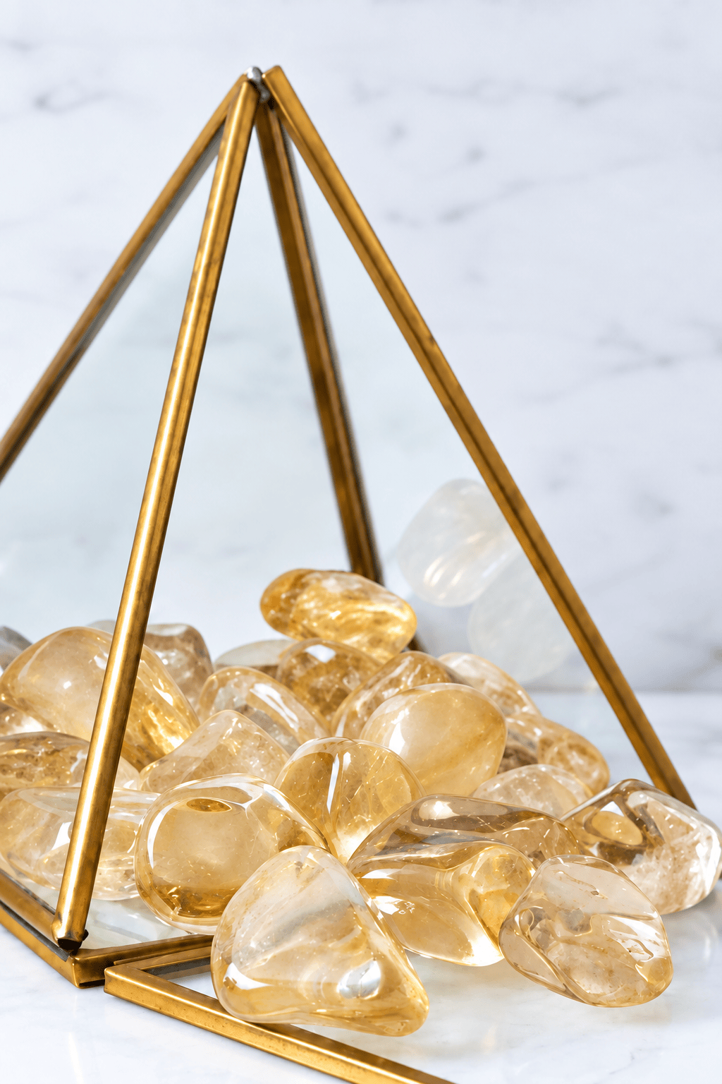 Tumbled citrine stone from Sacred Light Soundbaths and Crystals, showcasing its warm golden color and polished surface.