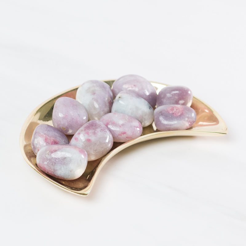 Pink tourmaline and lepidolite stones from Sacred Light Soundbaths and Crystals, showcasing vibrant pink and purple mineral clusters.