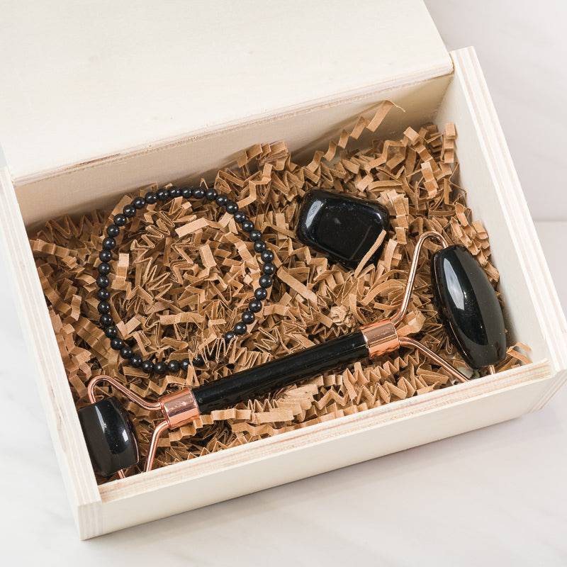 Black Obsidian face massage roller set with dual rollers, designed for soothing facial massage, by Sacred Light Soundbaths and Crystals.