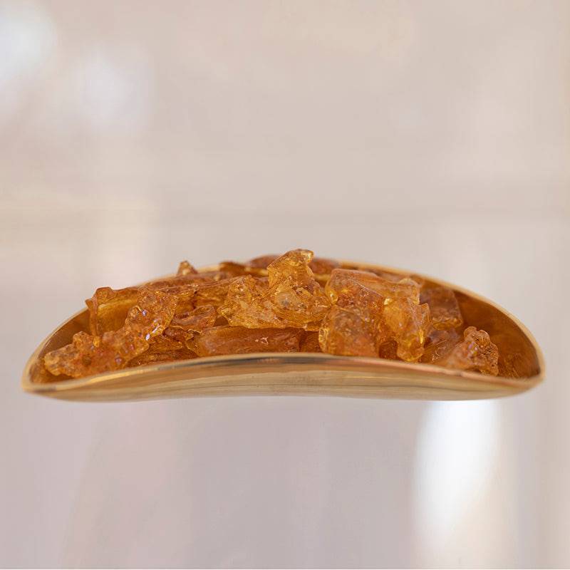 Colombian Amber stones from Sacred Light Soundbaths and Crystals, showcasing warm, translucent amber hues on a neutral background.