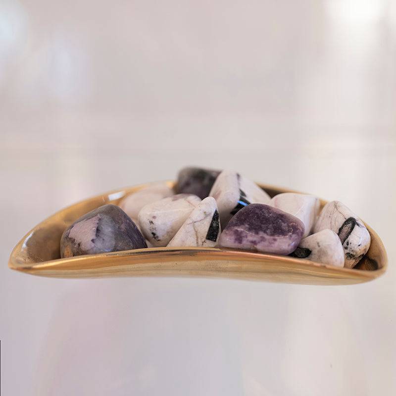 Set of tumbled tourmaline, lepidolite, and kunzite stones from Sacred Light Soundbaths and Crystals, showcasing vibrant natural mineral colors.