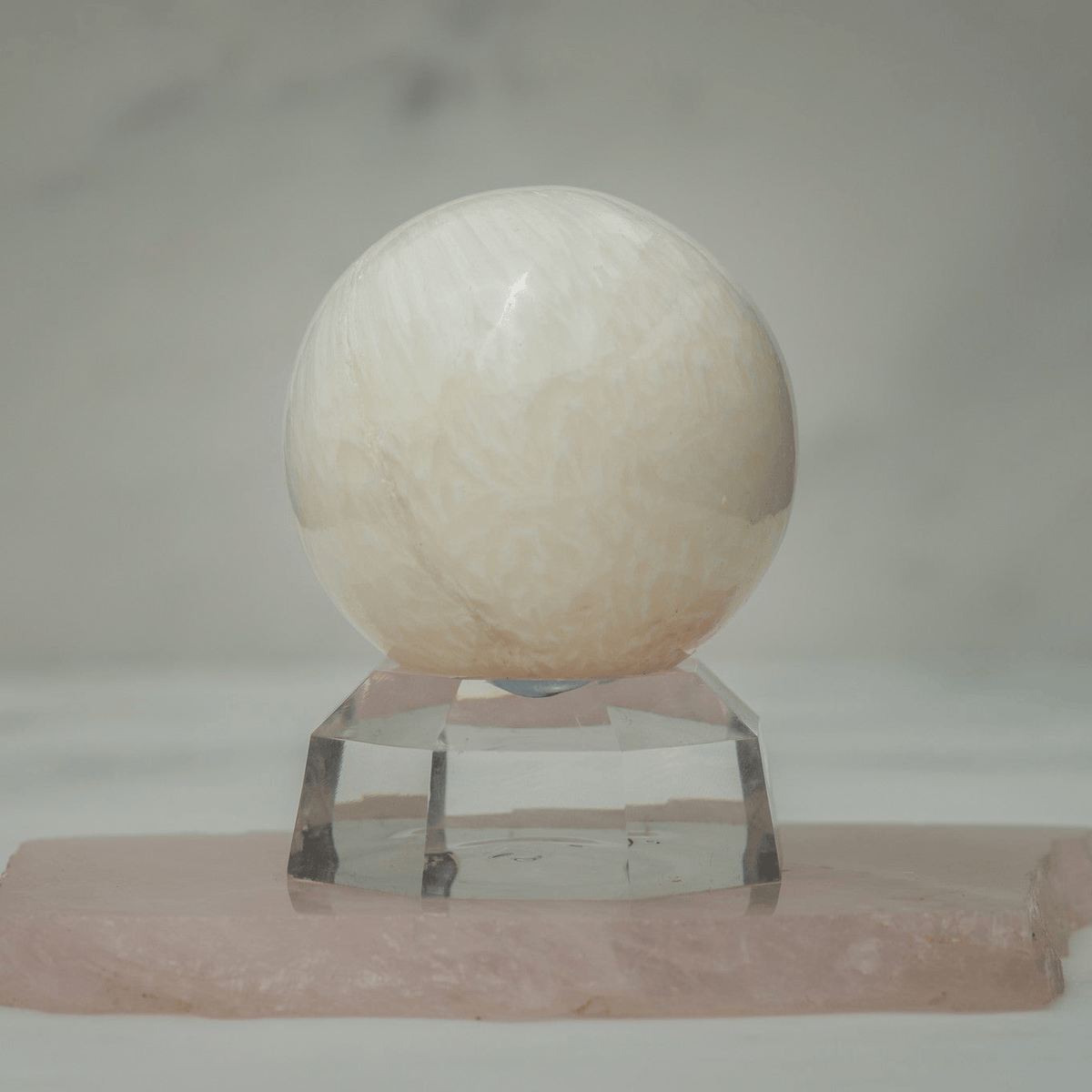 Polished Scolecite sphere from Sacred Light Soundbaths and Crystals, smooth and glossy stone for healing and meditation purposes.