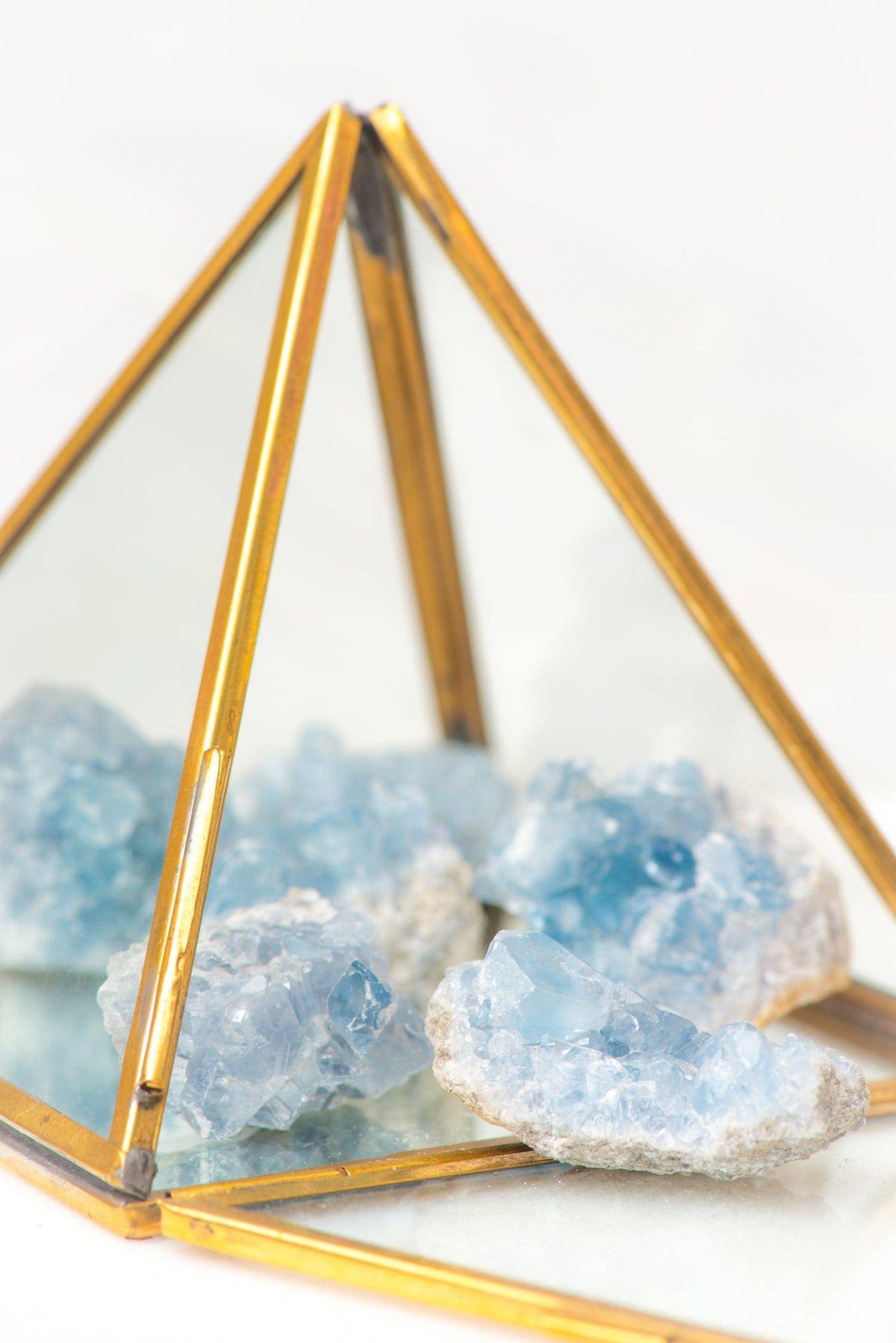 Mini Celestite geode stone from Sacred Light Soundbaths and Crystals, showing blue crystal clusters inside a rough rock cavity.