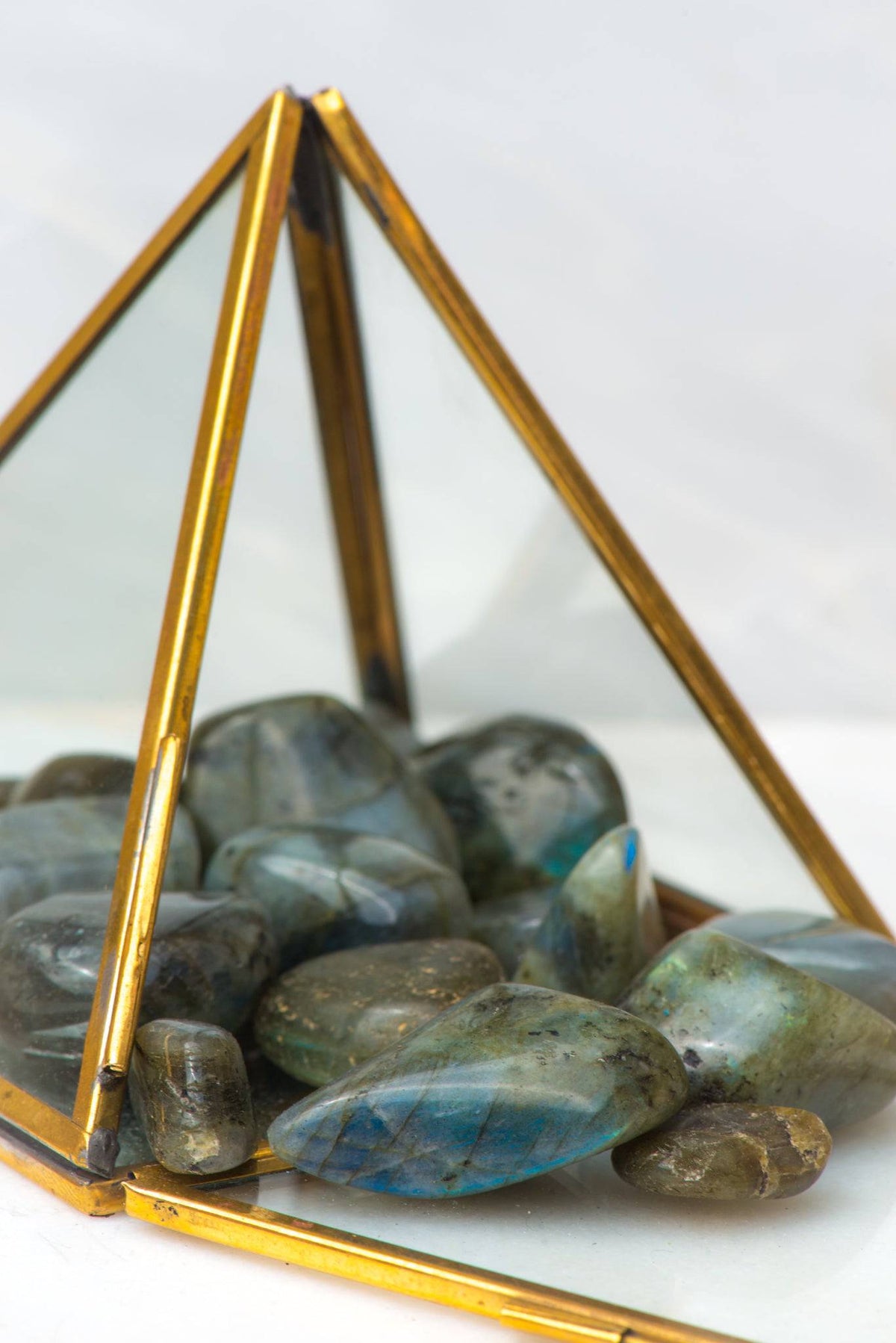 Labradorite stone from Sacred Light Soundbaths and Crystals, showcasing its iridescent, shimmering surface and natural mineral formation.