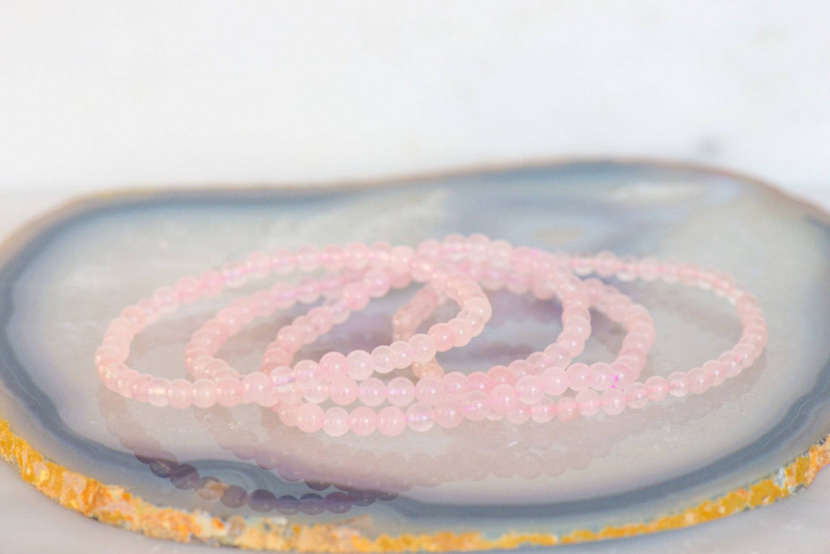 Dainty rose quartz bracelet from Milk and Honey featuring smooth pink stone beads on a delicate elastic band.