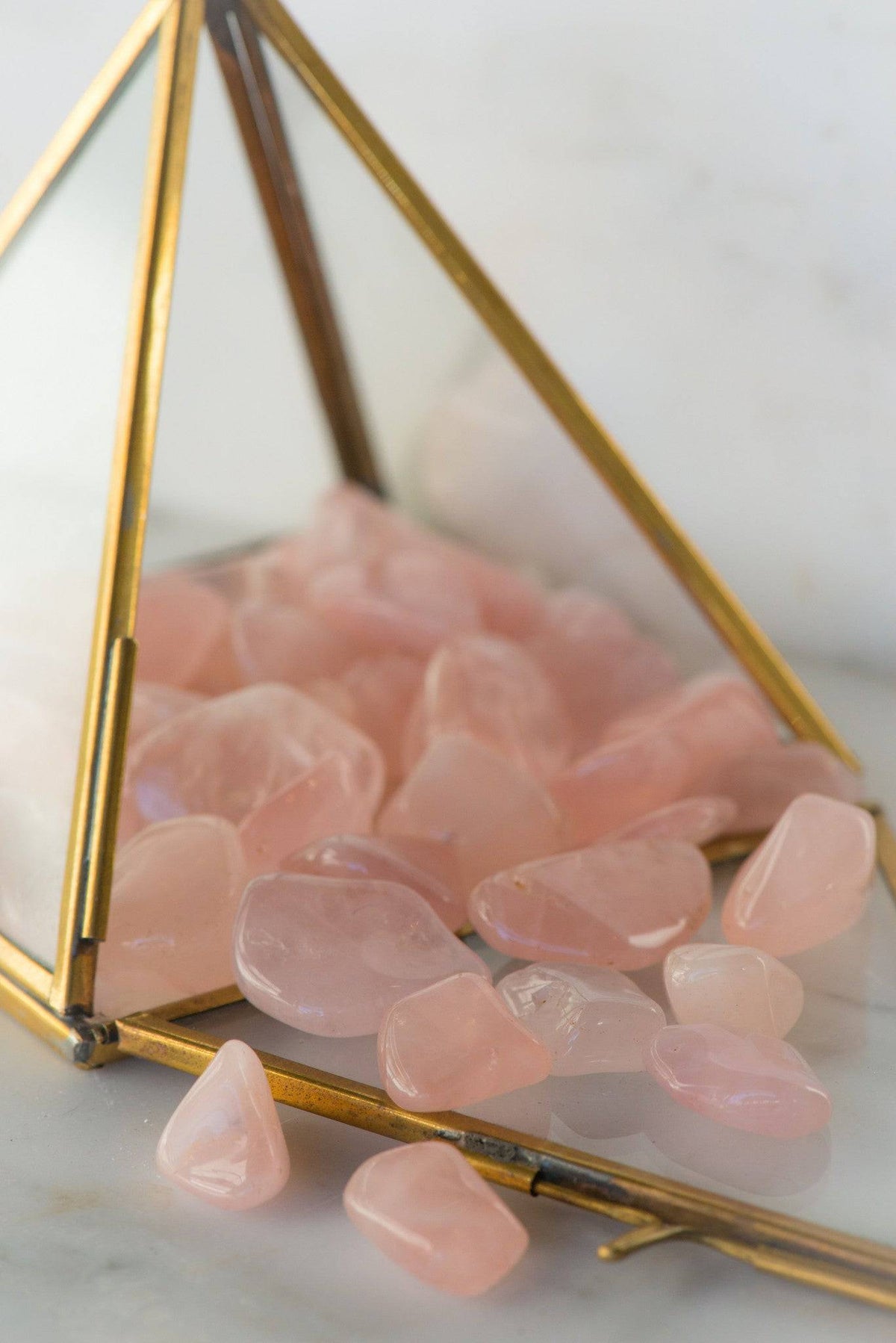 Tumbled rose quartz stone from Sacred Light Soundbaths and Crystals, smooth pink crystal with a polished finish.
