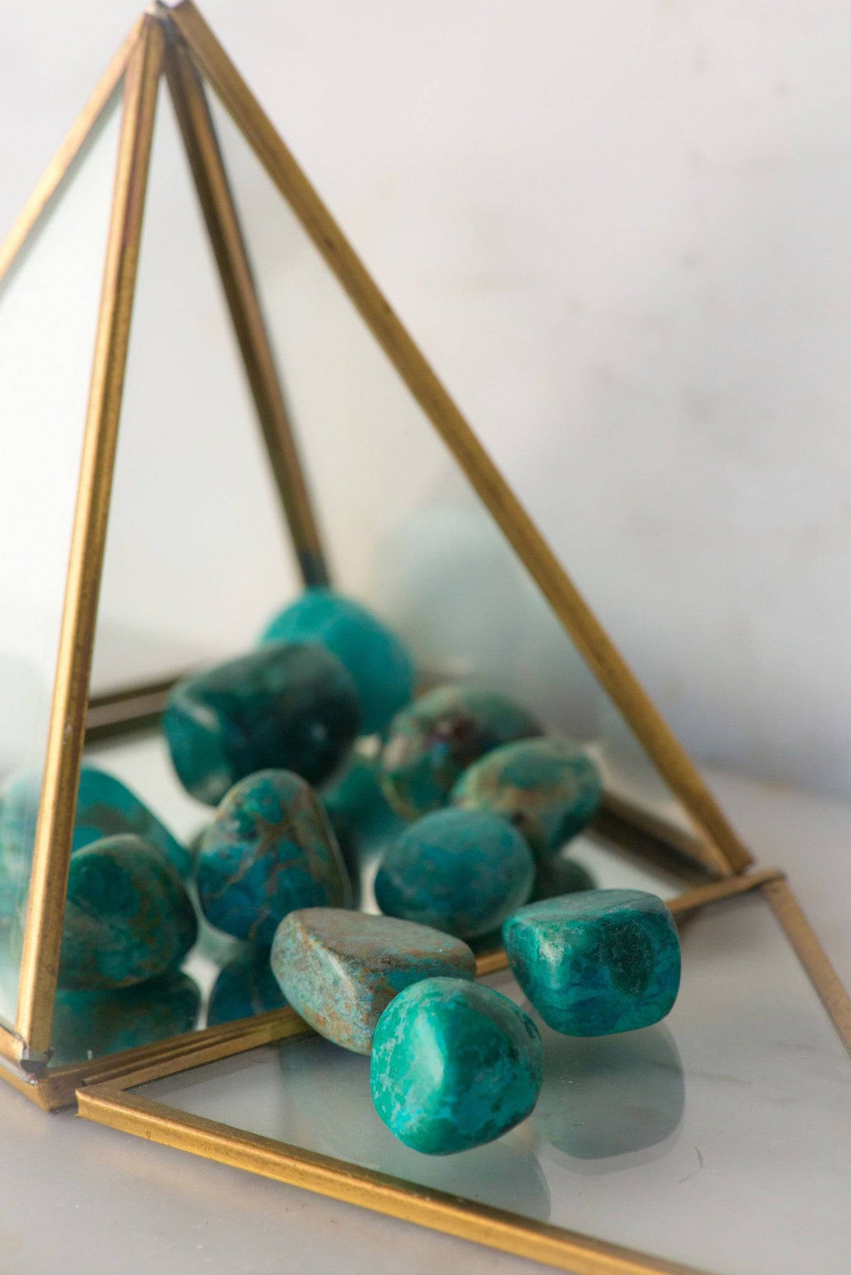 Tumbled Chrysocolla stone from Sacred Light Soundbaths and Crystals, showcasing its vibrant blue-green color and smooth polished surface.