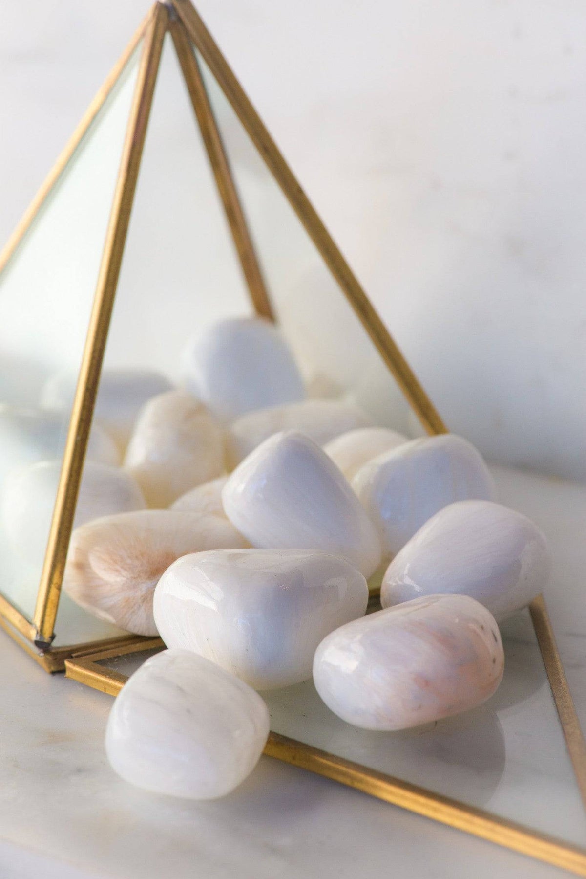 Tumbled Scolecite stone from Sacred Light Soundbaths and Crystals, polished mineral with smooth, translucent appearance.