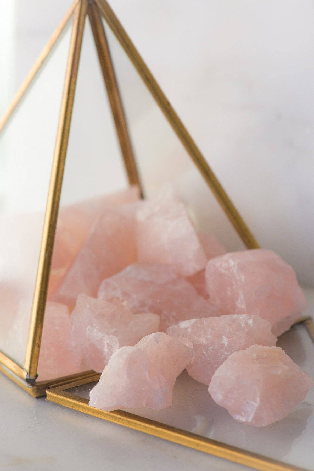 Natural rose quartz stone from Sacred Light Soundbaths and Crystals, showcasing its soft pink color and smooth polished surface.