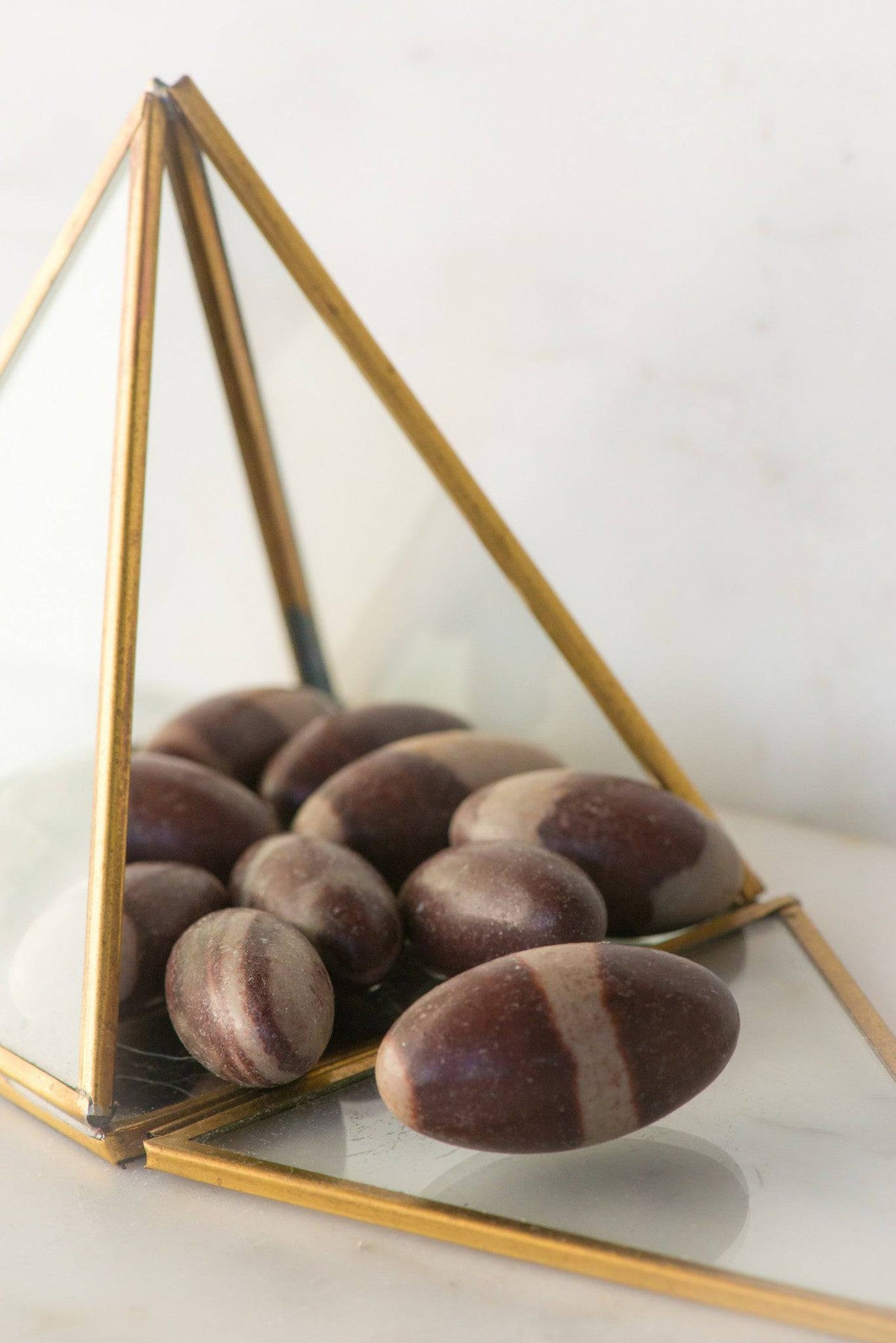 Natural Shiva Lingam stone from Sacred Light Soundbaths and Crystals, showcasing smooth, polished surface and unique natural patterns.