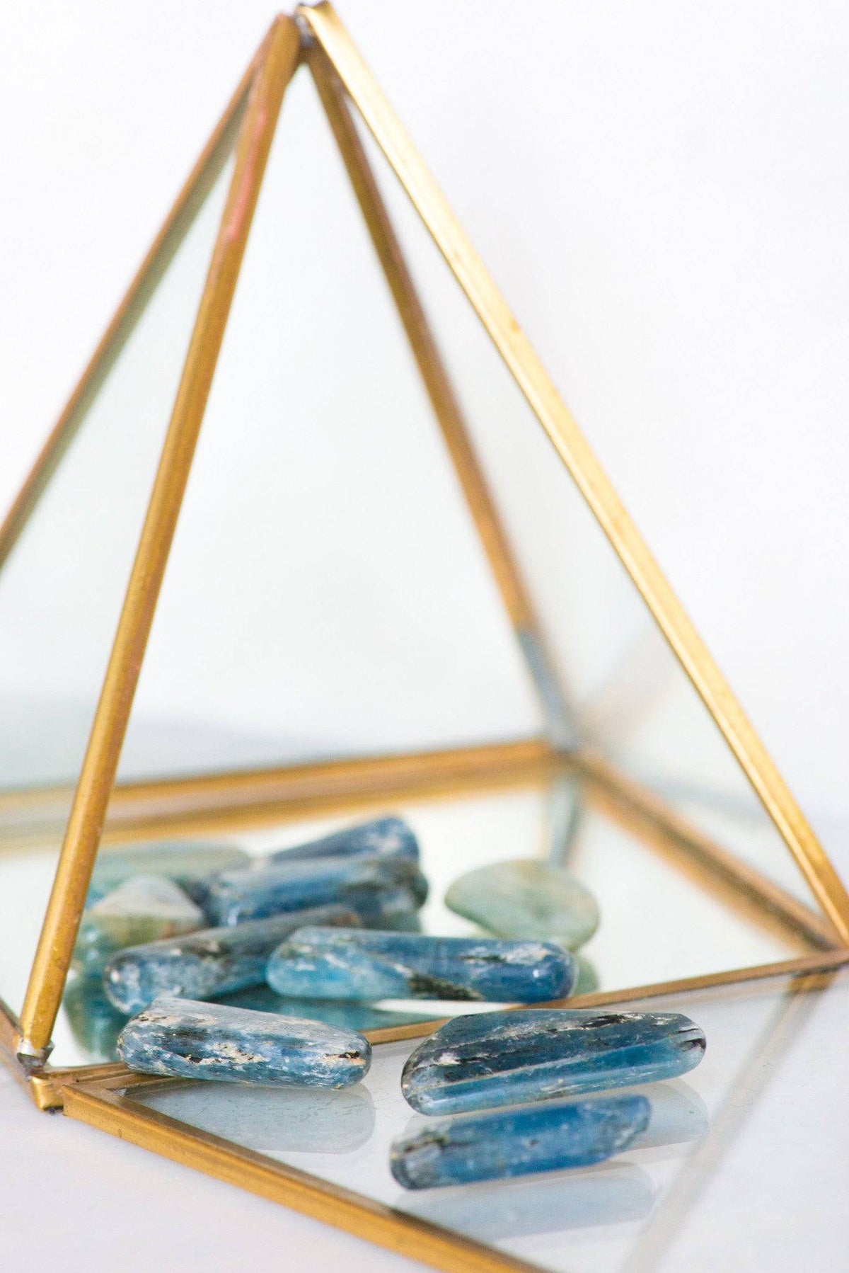 Tumbled blue Kyanite stone from Sacred Light Soundbaths and Crystals, smooth polished gemstone with vibrant blue color.