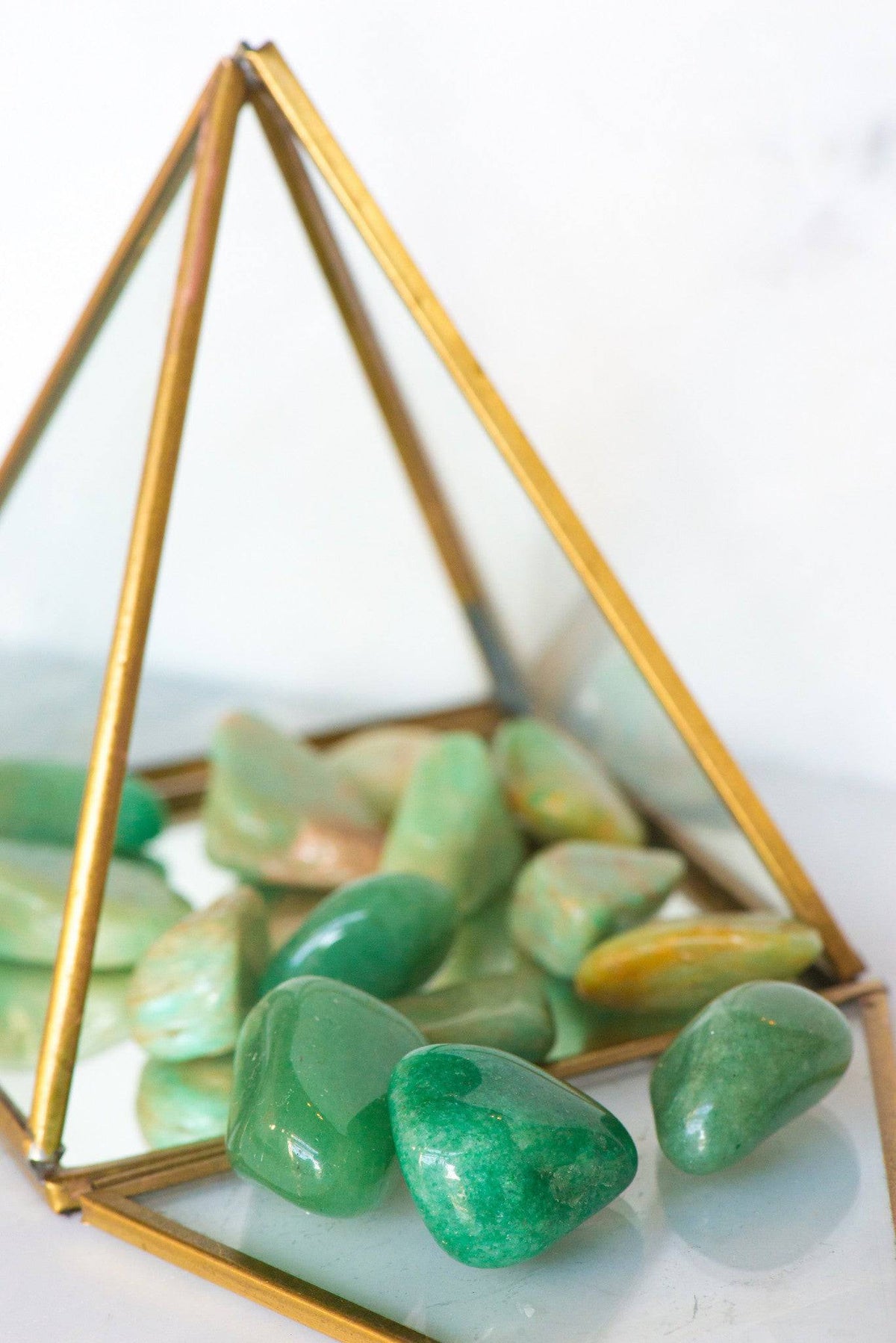 Tumbled green aventurine stone from Sacred Light Soundbaths and Crystals, smooth polished gemstone with a vibrant green hue.