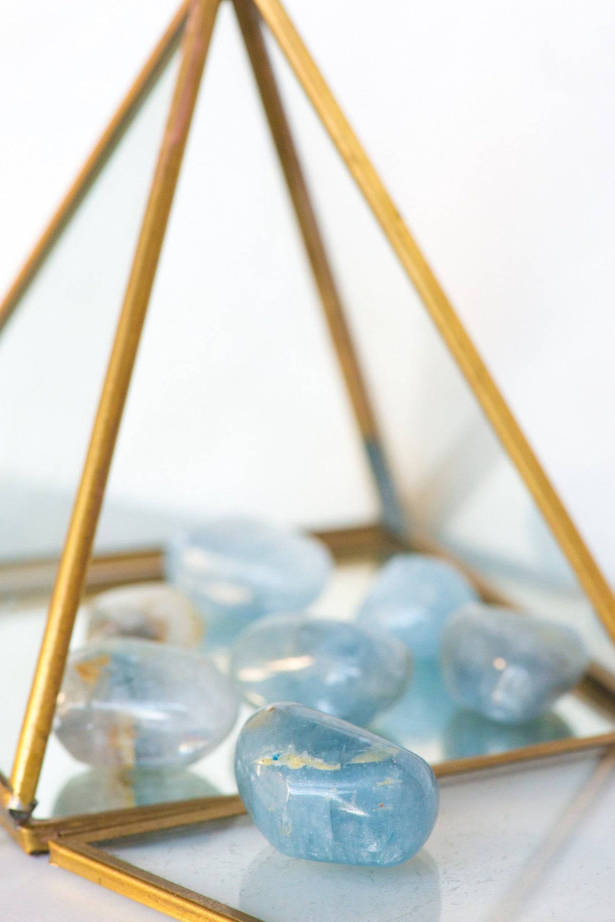 Tumbled Celestite stone from Sacred Light Soundbaths and Crystals, showcasing its light blue, smooth, polished surface.
