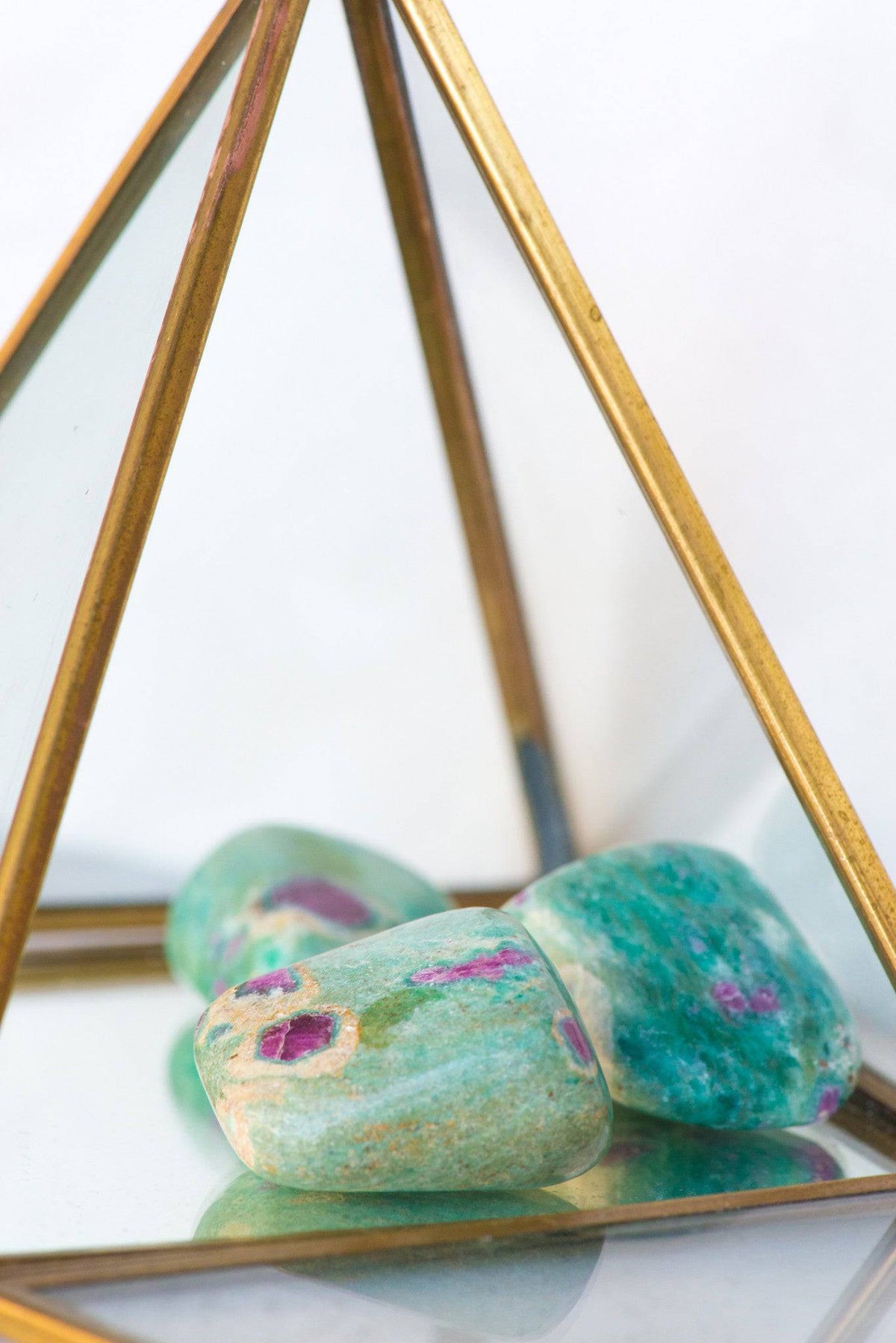 Tumbled Ruby Fuchsite stone from Sacred Light Soundbaths and Crystals, showcasing vibrant red and green mineral patterns.