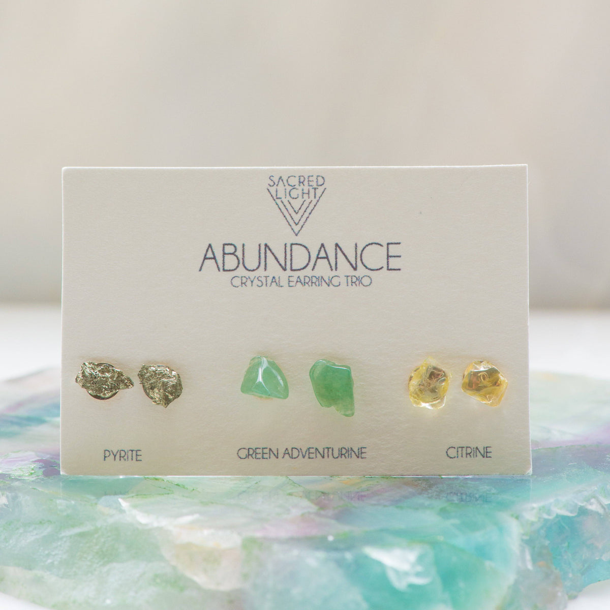 Sacred Light Soundbaths and Crystals Abundance Trio Earrings featuring gold and turquoise accents on silver hooks.