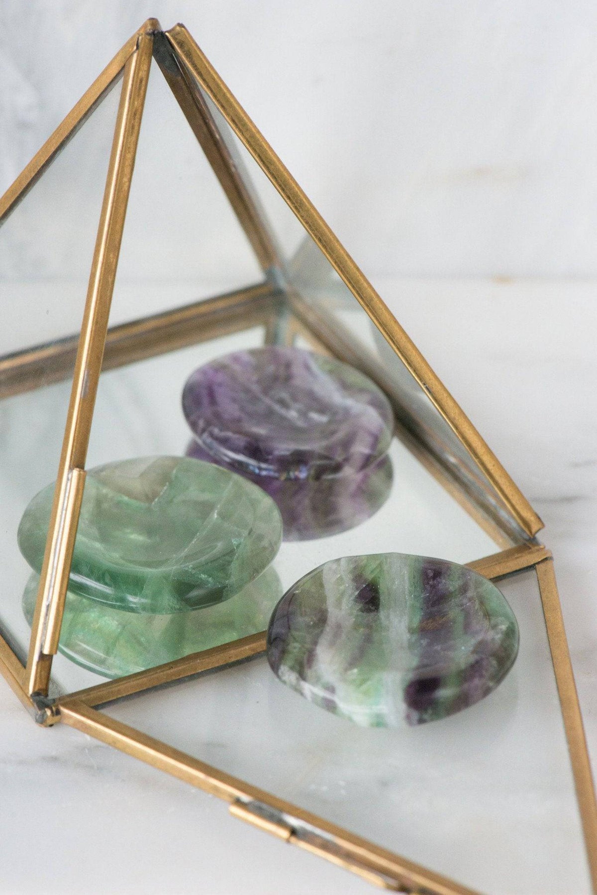 Smooth green fluorite palmstone from Sacred Light Soundbaths and Crystals, showcasing its vibrant color and polished surface.