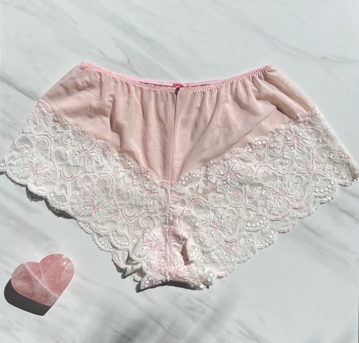 Limited edition Goddess Cotton Candy New York Lace underwear with ruby gem embellishment by Sacred Light, featuring intricate lace details.