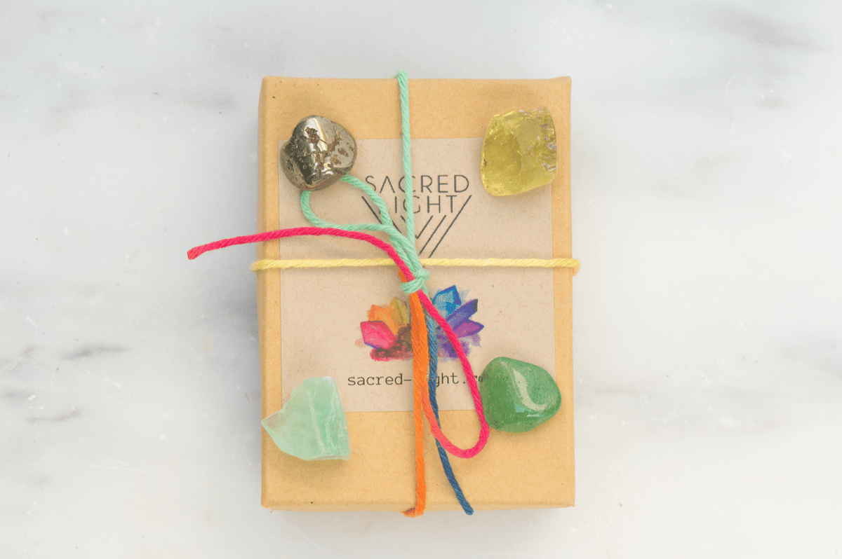 Sacred Light Soundbaths and Crystals Abundance Gem Stone Set featuring colorful polished gemstones arranged together.