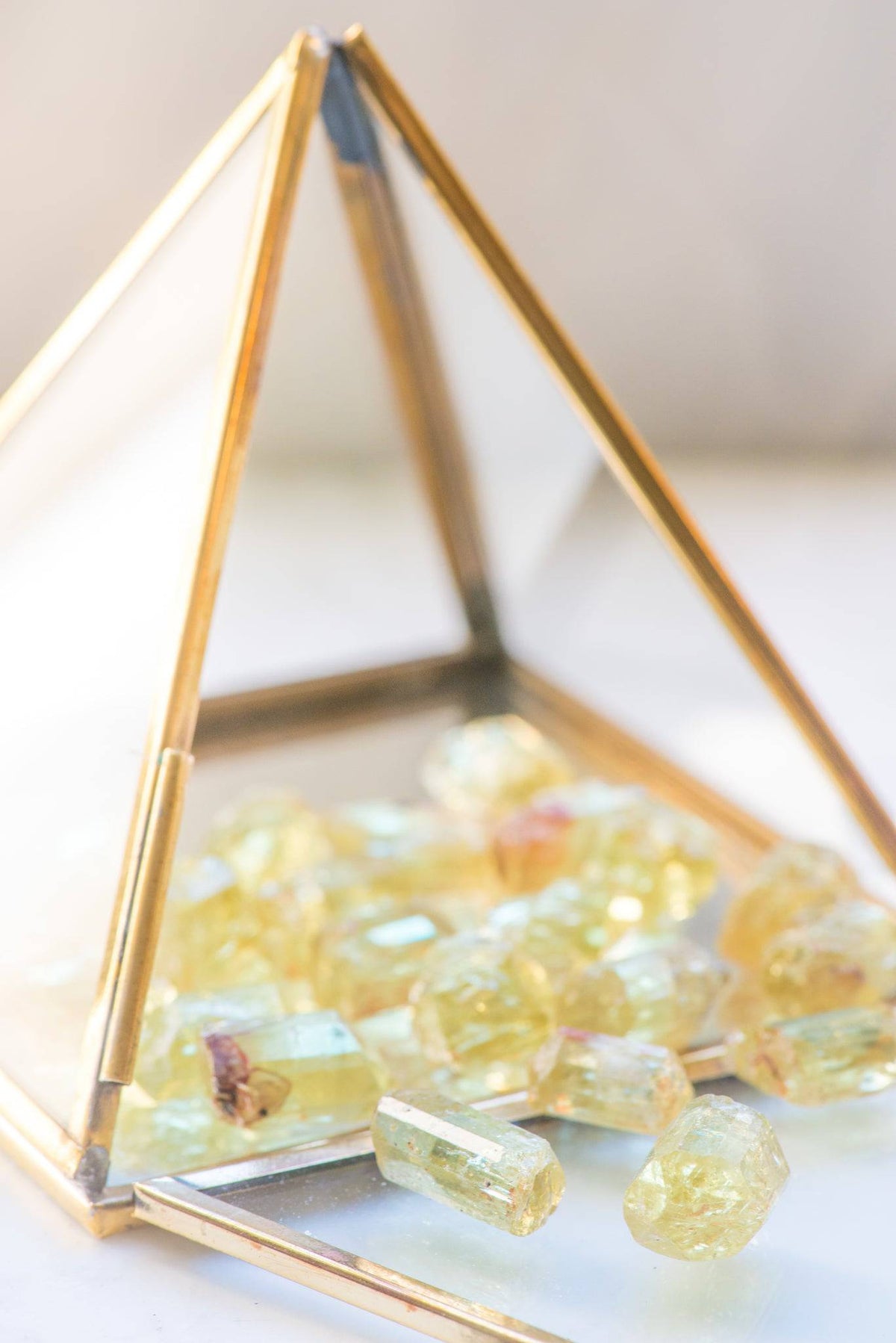 Yellow Apatite stone from Sacred Light Soundbaths and Crystals, showcasing its vibrant yellow color and smooth polished surface.