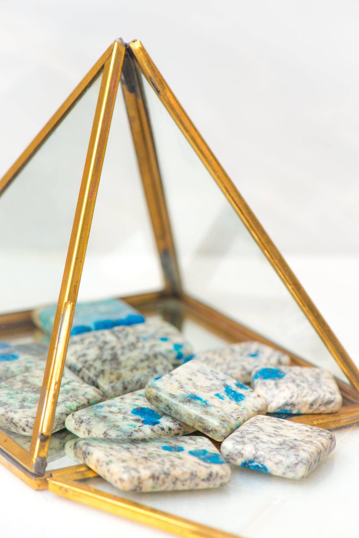 Smooth tumbled K2 stone from Sacred Light Soundbaths and Crystals, showcasing its unique gray and blue hues and polished surface.