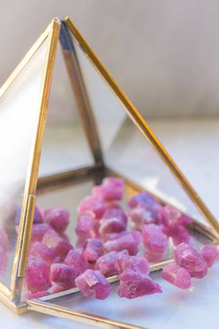 Natural pink tourmaline stone from Sacred Light Soundbaths and Crystals, showcasing its vibrant pink color and smooth polished surface.