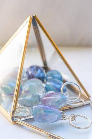 Colorful fluorite stone keychain from Sacred Light Soundbaths and Crystals, featuring a polished fluorite gemstone on a keyring.