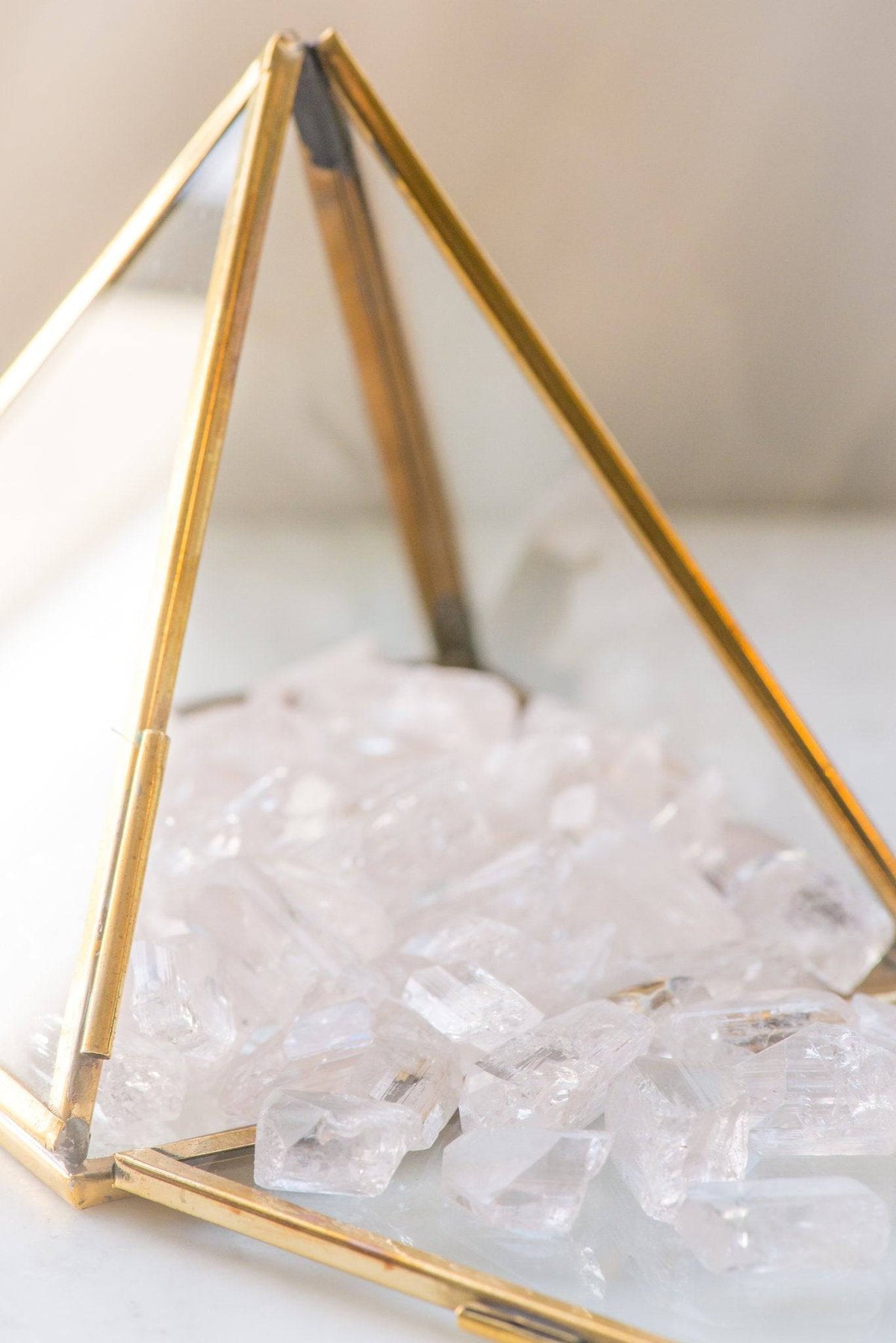 Smooth pale Danburite stone from Sacred Light Soundbaths and Crystals, showcasing its translucent, milky appearance.