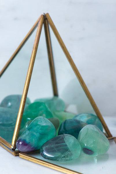 Tumbled fluorite stone from Sacred Light Soundbaths and Crystals, showing vibrant green and purple hues and smooth polished surface.