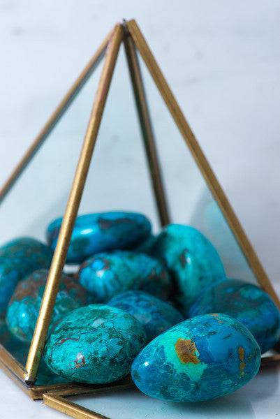 Tumbled Chrysocolla stone from Sacred Light Soundbaths and Crystals, showcasing vibrant blue-green mineral with smooth rounded surface.