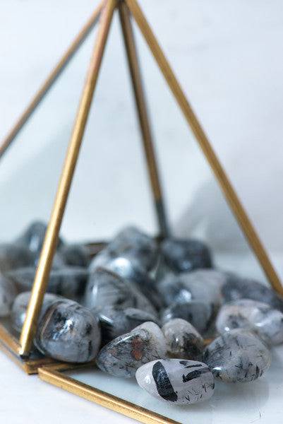 Tumbled black tourmaline stones with quartz crystals, natural healing crystals from Sacred Light Soundbaths and Crystals.