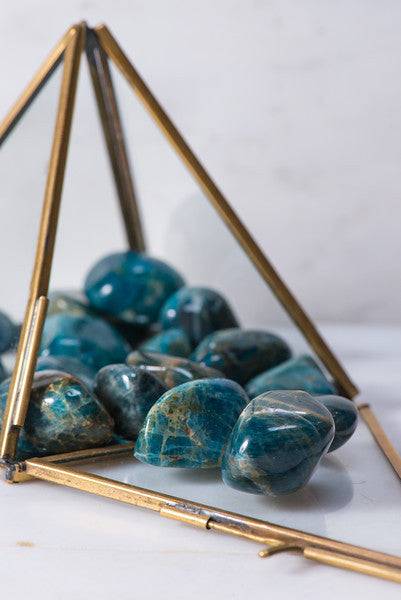 Tumbled blue apatite crystal from Sacred Light Soundbaths and Crystals, showcasing smooth, polished blue stone with natural variations.