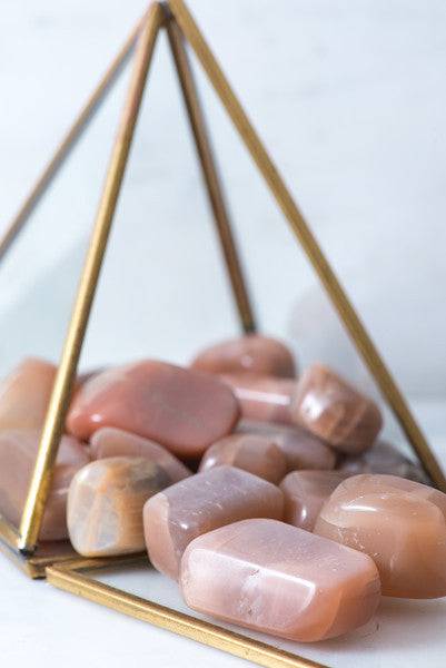 Tumbled chocolate moonstone stones from Sacred Light Soundbaths and Crystals, smooth, polished gemstone with warm brown hues.