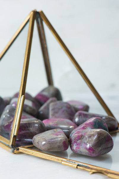 Tumbled Ruby Chalcedony crystal from Sacred Light Soundbaths and Crystals showcasing smooth, polished red and pink gemstone.