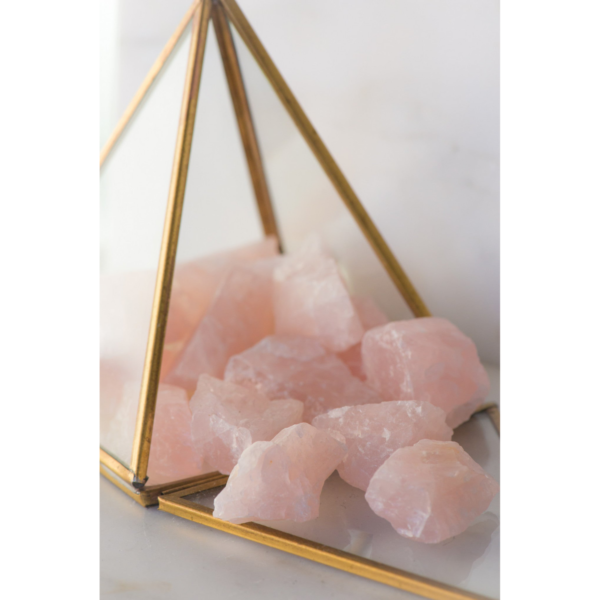 Natural rose quartz stone from Sacred Light Soundbaths and Crystals, showcasing its soft pink color and smooth polished surface.